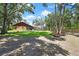 Lush backyard featuring green lawn, mature trees, and a serene atmosphere, perfect for relaxing and entertaining at 4706 Scott Rd, Lutz, FL 33558