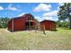 Outdoor view of barn featuring its metal roof, a staircase, a storage unit, and fencing at 4706 Scott Rd, Lutz, FL 33558