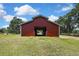Exterior view of the charming barn, offering ample space and potential for various uses on a beautiful property at 4706 Scott Rd, Lutz, FL 33558