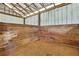 Inside view of one of the barn stalls featuring wooden panels and dirt flooring at 4706 Scott Rd, Lutz, FL 33558