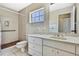 Neutral bathroom features a vanity with marble countertops and a shower with wood flooring at 4706 Scott Rd, Lutz, FL 33558