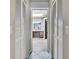 Open entryway to primary bath including linen closets and vanity with double sinks at 4706 Scott Rd, Lutz, FL 33558
