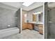Spacious bathroom with a skylight, offering both a shower and soaking tub at 4706 Scott Rd, Lutz, FL 33558
