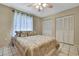 Bedroom featuring neutral decor, a ceiling fan, and double closets for storage at 4706 Scott Rd, Lutz, FL 33558