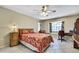 Cozy bedroom with tile floors, a ceiling fan, large windows, and comfortable furniture at 4706 Scott Rd, Lutz, FL 33558