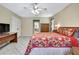 Comfortable bedroom features a ceiling fan, a wooden wardrobe and tiled floors at 4706 Scott Rd, Lutz, FL 33558