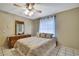 Bedroom featuring neutral decor, a ceiling fan, and a window providing natural light at 4706 Scott Rd, Lutz, FL 33558