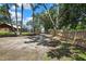 Long driveway lined with mature trees, fencing, and lush landscaping, leading to a private and inviting property at 4706 Scott Rd, Lutz, FL 33558