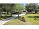 Charming home with a well-manicured front yard and a long driveway leading to a two-car garage at 4706 Scott Rd, Lutz, FL 33558