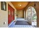 Enclosed front porch featuring tiled flooring, wood ceilings, and a charming entryway at 4706 Scott Rd, Lutz, FL 33558