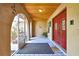 Inviting front porch with tiled floor, wood ceiling, archways, and a view to the garden at 4706 Scott Rd, Lutz, FL 33558
