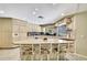 Spacious kitchen with an island featuring barstool seating and light wood cabinets at 4706 Scott Rd, Lutz, FL 33558