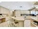 Kitchen with a breakfast bar, recessed lighting, and matching appliances with light wood cabinets at 4706 Scott Rd, Lutz, FL 33558