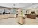 Bright kitchen featuring an island with seating, tile backsplash, and abundant cabinet space at 4706 Scott Rd, Lutz, FL 33558