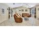 Spacious living room with tile floors, a ceiling fan, and plenty of natural light at 4706 Scott Rd, Lutz, FL 33558