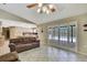 Living room with tile flooring and ceiling fan and kitchen view at 4706 Scott Rd, Lutz, FL 33558