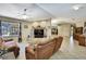 Bright living room features tile flooring, a ceiling fan, and a marble fireplace at 4706 Scott Rd, Lutz, FL 33558