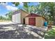 Exterior view of two outbuildings, offering potential for storage, workshop, or other uses on the property at 4706 Scott Rd, Lutz, FL 33558