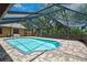 Screened-in pool surrounded by brick flooring with covered patio provides beautiful backyard views at 4706 Scott Rd, Lutz, FL 33558