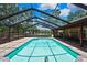 Inviting screened-in pool with brick pavers, outdoor seating, and a view of the backyard at 4706 Scott Rd, Lutz, FL 33558