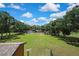 Expansive green property featuring lush grass, mature trees, and versatile outdoor space under a bright sky at 4706 Scott Rd, Lutz, FL 33558