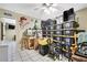 Storage room with tile flooring and stacked black storage containers and an air filtration system at 4706 Scott Rd, Lutz, FL 33558