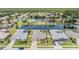 Wide aerial shot of a residential area with a long lake and many houses at 5049 Rushbrook Rd, Land O Lakes, FL 34638