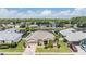 Aerial view of a home in a community with a lake and well-maintained lawns at 5049 Rushbrook Rd, Land O Lakes, FL 34638