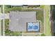 Aerial of backyard with pool, screened enclosure, privacy fence and view of a pond at 5049 Rushbrook Rd, Land O Lakes, FL 34638