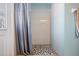 Bathroom shower with pebble floor and white tiled walls, lit by an overhead light at 5049 Rushbrook Rd, Land O Lakes, FL 34638