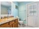 Bright bathroom with blue walls, granite vanity, and direct access to the outdoors at 5049 Rushbrook Rd, Land O Lakes, FL 34638