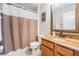 Bright bathroom featuring a vanity with granite countertop and a shower with neutral-toned curtain at 5049 Rushbrook Rd, Land O Lakes, FL 34638