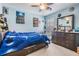 Comfortable bedroom with a unique blue galaxy-themed bed and ample storage space at 5049 Rushbrook Rd, Land O Lakes, FL 34638