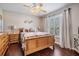 Inviting bedroom boasting hardwood floors, a large bed, and bright natural lighting at 5049 Rushbrook Rd, Land O Lakes, FL 34638