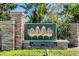 Pine Glen deed-restricted community sign, lush foliage, and welcoming entrance at 5049 Rushbrook Rd, Land O Lakes, FL 34638