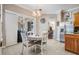 Cozy dining area with stylish chandelier, connecting seamlessly to kitchen and living spaces at 5049 Rushbrook Rd, Land O Lakes, FL 34638