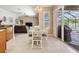 Cozy dining area featuring a white table set near sliding glass doors that open up to the pool at 5049 Rushbrook Rd, Land O Lakes, FL 34638