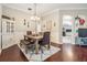 Formal dining area with rustic wood table, bench seating, and decorative lighting at 5049 Rushbrook Rd, Land O Lakes, FL 34638