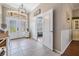 Bright entryway with decorative glass doors and an ornate chandelier at 5049 Rushbrook Rd, Land O Lakes, FL 34638