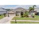 Charming single-story home with a well-manicured lawn and a two-car garage at 5049 Rushbrook Rd, Land O Lakes, FL 34638