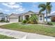 Charming home with well-manicured lawn, lush landscaping, and inviting curb appeal at 5049 Rushbrook Rd, Land O Lakes, FL 34638