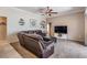 Comfortable living room showcasing a plush leather sectional and modern entertainment center at 5049 Rushbrook Rd, Land O Lakes, FL 34638