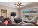 Spacious living room featuring a large leather couch and sliding glass doors to the pool area at 5049 Rushbrook Rd, Land O Lakes, FL 34638