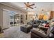 Open-concept living room with seamless flow to the outdoor pool area and modern kitchen at 5049 Rushbrook Rd, Land O Lakes, FL 34638
