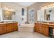 Large primary bathroom features double vanity sinks and separate soaking tub at 5049 Rushbrook Rd, Land O Lakes, FL 34638
