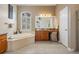 Luxurious bathroom features a large soaking tub, vanity, and lots of natural light at 5049 Rushbrook Rd, Land O Lakes, FL 34638