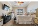 Neutral main bedroom with ceiling fan, television, and dresser offers a relaxing space at 5049 Rushbrook Rd, Land O Lakes, FL 34638