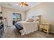 Comfortable main bedroom features a ceiling fan, sliding doors to a lanai, and neutral paint at 5049 Rushbrook Rd, Land O Lakes, FL 34638