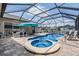Sparkling pool and spa surrounded by a screened enclosure and beautiful brick pavers at 5049 Rushbrook Rd, Land O Lakes, FL 34638
