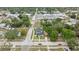 An aerial view of a two-story home with a dark roof, white siding, green lawn, and newly installed white fence at 5055 2Nd S Ave, St Petersburg, FL 33707